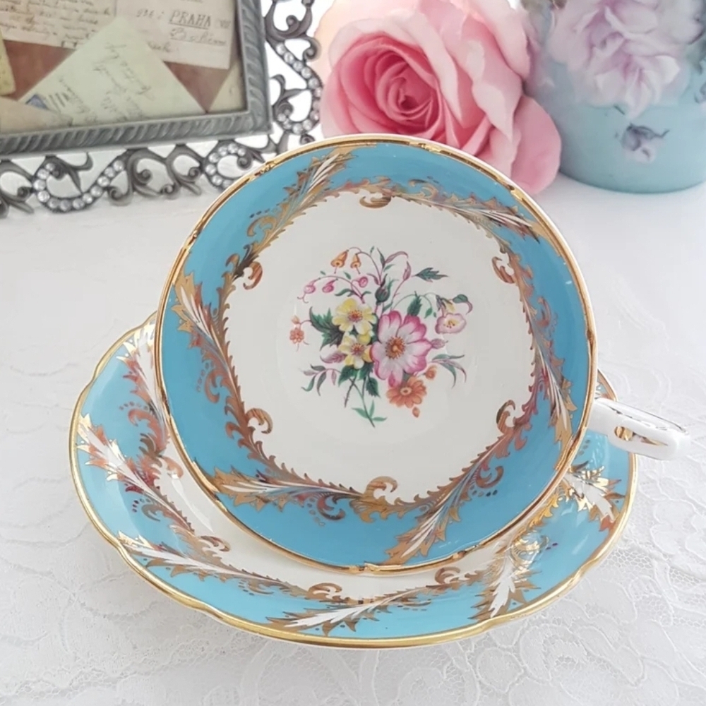 Paragon Tea Cup and Saucer, Floral Center, Gold Feather Pattern on Eggshell Blue